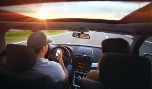 Person texting and driving in Baltimore, MD